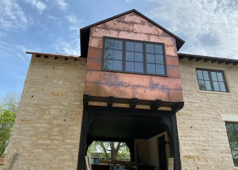 Copper metal panel facade on a stone building for Skylight Installation in Helena Valley West Central