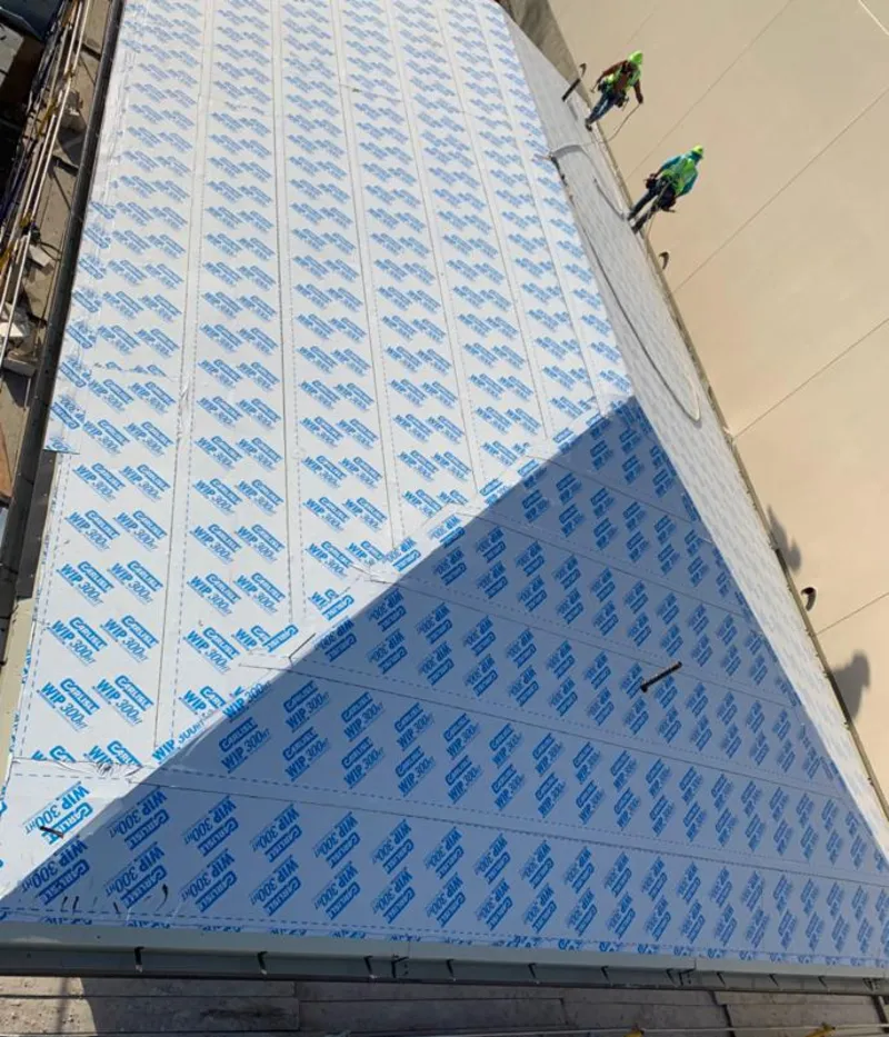 Professional roofers installing underlayment on a metal roof in Helena Valley West Central